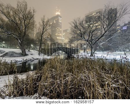 Gapstow Bridge is one of the icons of Central Park Manhattan in New York City during snow storm at night
