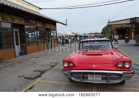 BANGKOK THAILAND - SEPTEMBER 17 2016: Old vintage red car at Night market Srinakarin road that name is train market. This market is open every Wednesday to sunday.