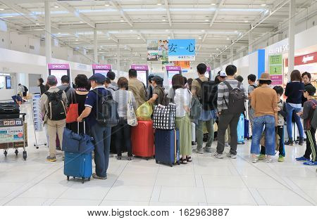 OSAKA JAPAN - OCTOBER 18, 2016, 2016: Unidentified people check in at Peach airline counter Kanasai airport. Peach airline is a LCC based in Kansai airport.