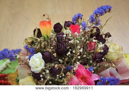 Bouquet of dried flowers for wedding on wooden table.