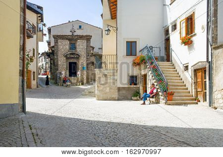 Pescocostanzo Italy - August 19 2006: Local people between the traditional architecture of the country center