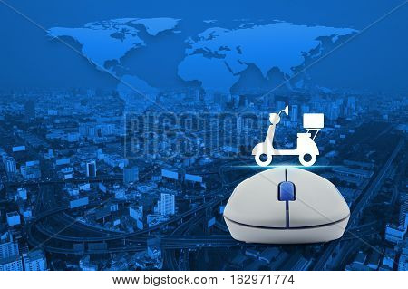Wireless computer mouse with motor bike icon over city tower street and expressway Business internet delivery service concept Elements of this image furnished by NASA
