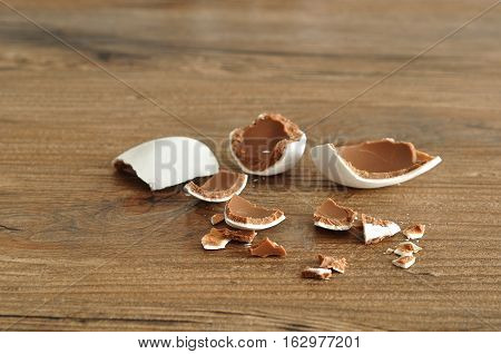 A white chocolate coated easter egg broken into pieces
