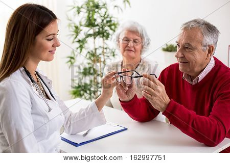 Doctor Ophthalmologist Giving Glasses To Patient After Eyes Exam