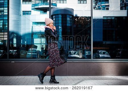 Young Female Student In Warm Autumn Clothes Coming Out Of The House With A Backpack With Books  Arou