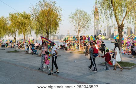 4 October 2018, Wuhan China : Chinese Family Holding A Kite And Kite Stalls On Yangtze Riverside Par