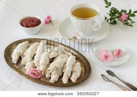 Traditional Romanian Or Moldavian Shortcake Cookies With Jam Stuffing And A Cup Of Tea On The Light 
