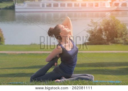 Beautiful Young Woman Practicing Yoga And Stratching