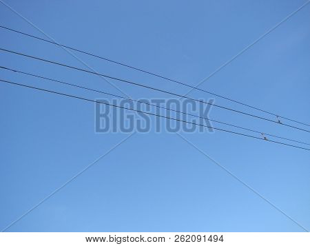 Wires Pole With Blue Sky. Electrical Wires On A Background. Electric Cables. Power Cable With Blue S