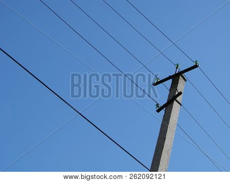 Wires Pole With Blue Sky. Electrical Wires On A Background. Electric Cables. Power Cable With Blue S