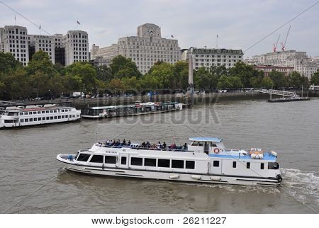 LONDON â SEPTEMBER 24: A City Cruises tour boat sails on the Thames River on September 24, 2011 in London, England. Thames is the longest river in England with 346 km long.
