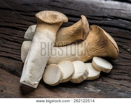 King oyster mushrooms on the wooden background.
