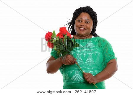 Studio Shot Of Happy Fat Black African Woman Smiling While Holdi