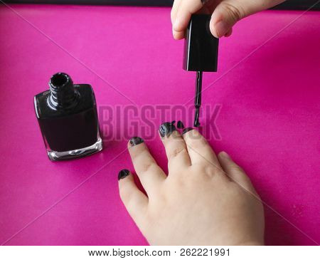 Children's Hands Paint Their Nails With Black Nail Polish. Children's Manicure. Black Manicure On Ch