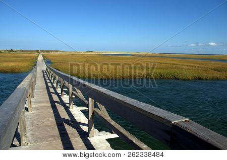 A Boardwalk Built In 1875 Crosses Over The Marsh To Town Neck Beach.  Located In Sandwich Ma, Cape C