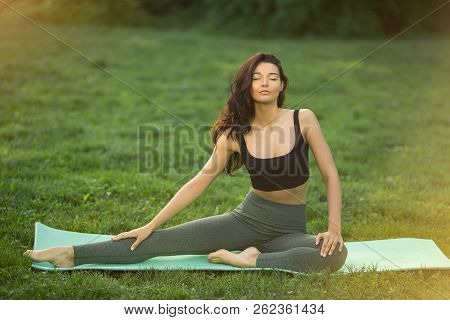 Healthy Sports Lifestyle. Young Woman Doing Workout For Stretching Body. Young Attractive Slim Girl 