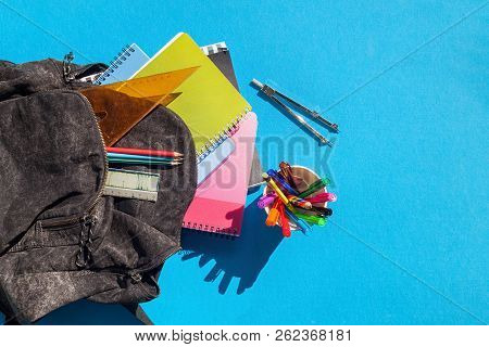 Overview Of Schhol Bag And Its Content On A Blue Background. Backpack With School Supplies - Noteboo