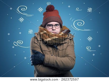Young hipster frozen boy with doodled snowflakes and windy concept