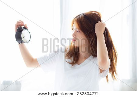 Beautiful Young Asian Woman Wake Up In Morning Annoyed Alarm Clock Holding Hand, Standing Hurry Wake
