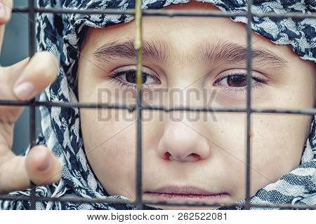 Crying Refugee Girl From The East In A Headscarf