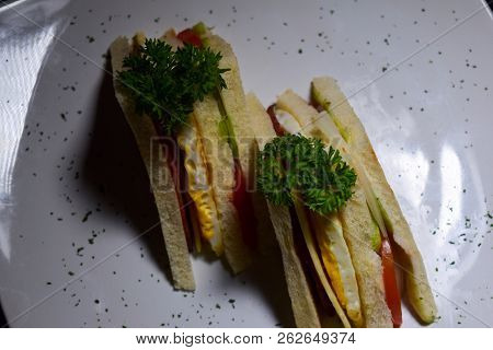 Sandwich With Ham, Cheese, Tomatoes, Lettuce, And Toasted Bread. Above View Vintage On Black Backgro