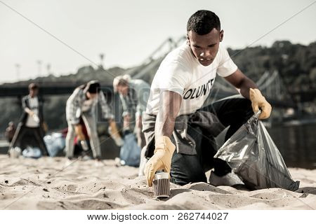 Handsome Student Enjoying The Process Of Volunteering While Cleaning Up The Trash