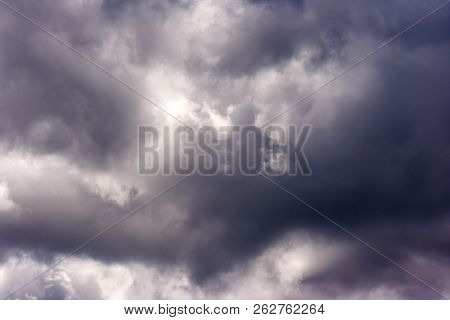 Storm Cloud On Sunny Day. Light In The Dark And Dramatic Storm Clouds. Background Of Storm Clouds Be