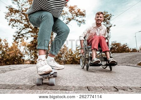 Active Disabled Man Competing With His Friend And Riding His Wheelchair