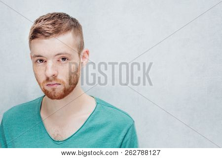 Man With A Sad Facial Expression On A Gray Background