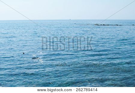Slim Stone Bouncing On The Surface Of The Sea
