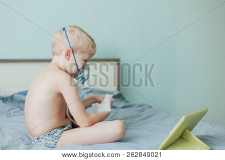 Small Boy Does Therapeutic Inhalation Using A Nebulizer