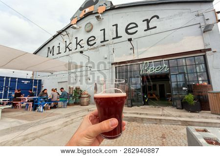 Copenhagen, Denmark - Sept 9: Glass Of Craft Beer Past The Bar By Mikkeller Brewery With Visitors An