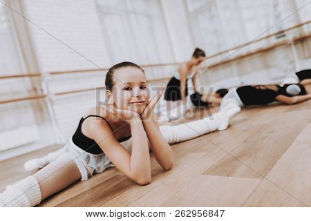 Ballet Training Of Girls On Floor With Teacher. Classical Ballet. Girl In Balerina Tutu. Training In