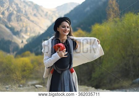 Beautiful Young Mother With Her Infant Baby In Sling Outdoor. Woman Is Carrying Her Child And Travel