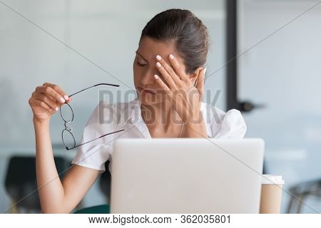 Millennial Woman Taking Off Glasses Tired Of Computer Work