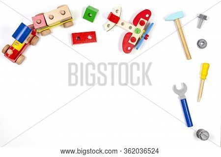 Kids Toys Background. Wooden Train, Construction Plane And Toy Tools Kit On White Background. Top Vi
