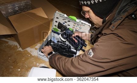 Strasbourg, France - Mar 3, 2020: Male Worker Unboxing Parcel Containing New Best In Class Multiple 