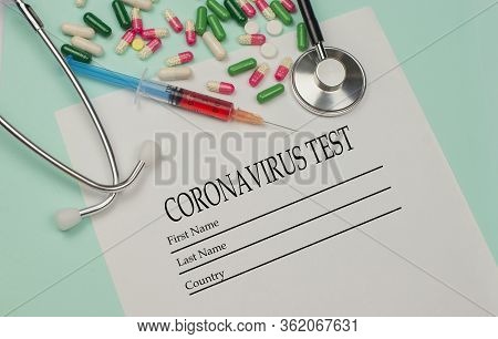 A Syringe With A Blood Test And A Stethophonendoscope With A Patient Questionnaire And Tablets For A