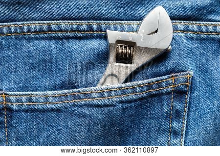 Blue Jeans Front Pocket With Adjustable Spanner. Close Up View. Libor Day Concept