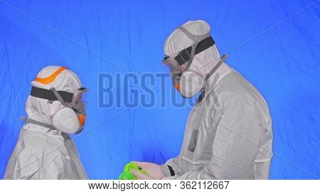 Doctor In Respirator Show A Virus Model. Slow Motion. Woman Wearing Protect Medical Aerosol Spray Pa