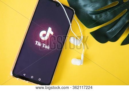 Tver, Russia-april 9, 2020, The Tik Tok Logo On A Smartphone Screen On An Yellow Background With Hea