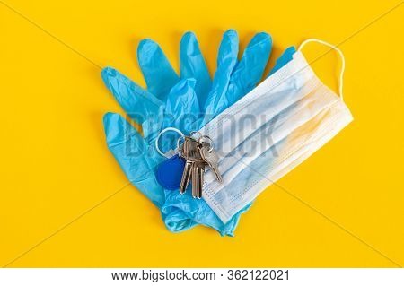 Medical Mask And Gloves Lie With Keys On A Background Of Lush Lava Color, Protection Disease. Medica