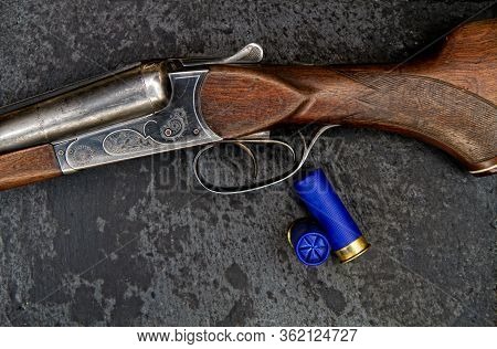 Old Classic Double-barreled Hunting Rifle Of The Twelfth Caliber And Cartridges For It On A Dark Bac