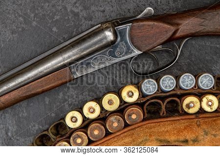 Old Classic Double-barreled Hunting Rifle Of The Twelfth Caliber And Cartridges For It On A Dark Bac