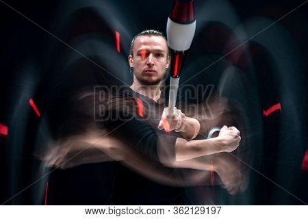 Juggler Throws Clabs In Motion With Smoothed Track. Isolated On Black