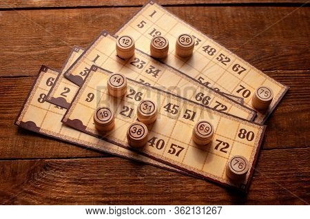 Family Vintage Interesting Game, Bingo Cards And Bingo Balls Lie On A Wooden Table