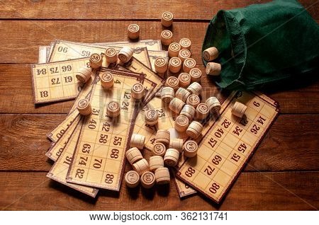 Family Vintage Interesting Game, Bingo Cards And Bingo Balls Lie On A Wooden Table