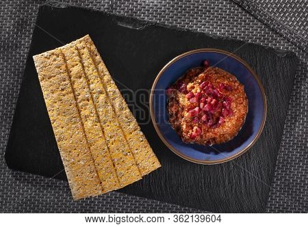 Muhammara With And Crackers For Dipping On Slate Seen From Above