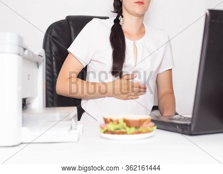 Girl Office Worker Near Which Lies A Sandwich Holding On To A Stomach In Which There Is Pain And Inf