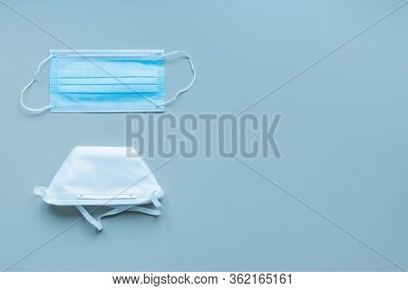 Disposable Medical Mask And Disposable Respirator On Blue Background. Choosing Right Type For Protec